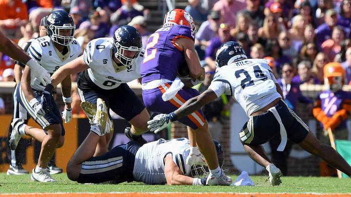 Clemson Tigers quarterback Tait Reynolds (2) is tackled by Charleston Southern Buccaneers defensive lineman Josiah Wyatt (0) and Charleston Southern Buccaneers linebacker Angel Miles (24) during the NCAA football game Saturday, Oct. 17, 2026 at Memorial Stadium in Clemson, South Carolina. Clemson Tigers quarterback Tait Reynolds (2) is tackled by Charleston Southern Buccaneers defensive lineman Josiah Wyatt (0) and Charleston Southern Buccaneers linebacker Angel Miles (24) during the NCAA football game Saturday, Oct. 17, 2026 at Memorial Stadium in Clemson, South Carolina.