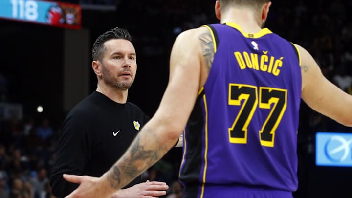 Mar 29, 2025; Memphis, Tennessee, USA; Los Angeles Lakers head coach JJ Redick talks with Los Angeles Lakers guard Luka Doncic (77) during the fourth quarter against the Memphis Grizzlies at FedExForum. Mandatory Credit: Petre Thomas-Imagn Images