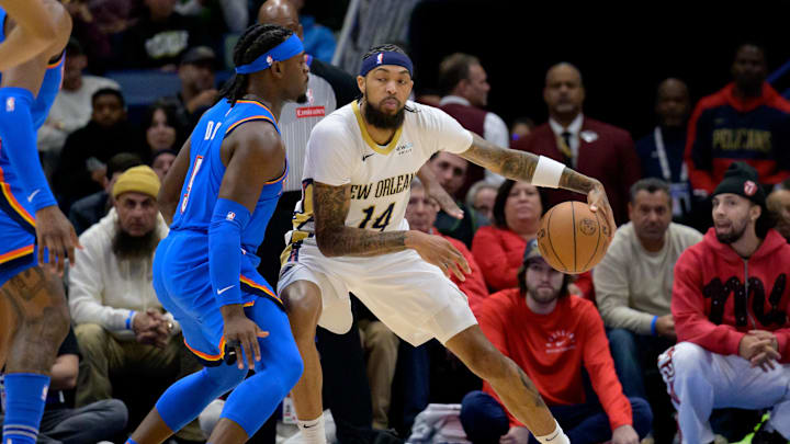 Dec 7, 2024; New Orleans, Louisiana, USA; New Orleans Pelicans forward Brandon Ingram (14) dribbles against Oklahoma City Thunder guard Luguentz Dort (5) during the first half at Smoothie King Center. Mandatory Credit: Matthew Hinton-Imagn Images Dec 7, 2024; New Orleans, Louisiana, USA; New Orleans Pelicans forward Brandon Ingram (14) dribbles against Oklahoma City Thunder guard Luguentz Dort (5) during the first half at Smoothie King Center. Mandatory Credit: Matthew Hinton-Imagn Images