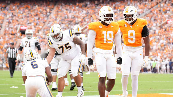 Tennessee defensive linemen Joshua Josephs (19) and Mariyon Dye (9) celebrate after taking down ETSU quarterback Jacolby Criswell (6) in an NCAA college football game on September 6, 2025, in Knoxville, Tennessee.