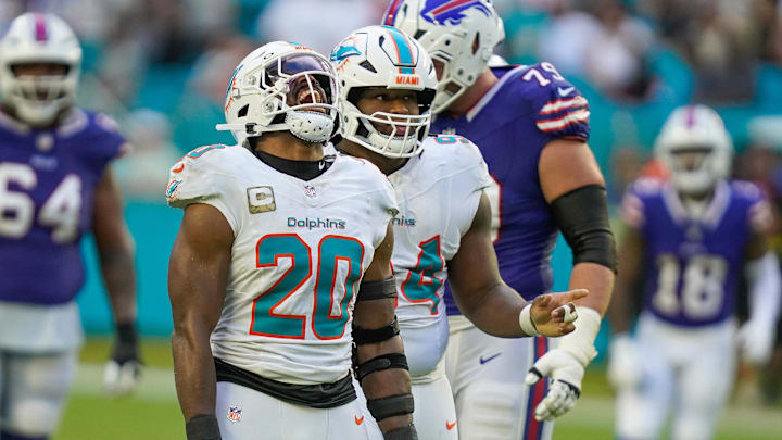 Miami Dolphins linebacker Jordyn Brooks (20) and defensive tackle Jordan Phillips (94) celebrate a fourth down stop against the Buffalo Bills during the fourth quarter at Hard Rock Stadium. Mandatory Credit: Jeff Romance-Imagn Images