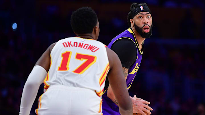 Jan 3, 2025; Los Angeles, California, USA; Los Angeles Lakers forward Anthony Davis (3) controls the ball against Atlanta Hawks forward Onyeka Okongwu (17) during the second half at Crypto.com Arena. Mandatory Credit: Gary A. Vasquez-Imagn Images