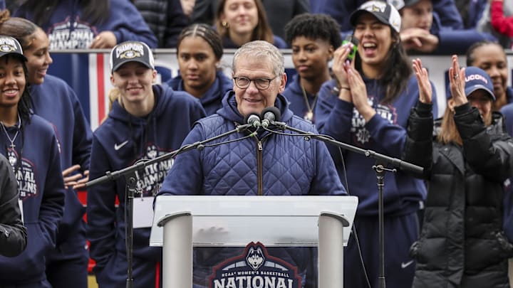 Apr 13, 2025; Hartford, CT, USA;   UConn Huskies head coach Geno Auriemma addresses the crowd while UConn student-athlete Paige Bueckers looks on during the Final Four champions victory parade and rally outside of the XL Center in Hartford, CT. Mandatory Credit: Scott Rausenberger-Imagn Images