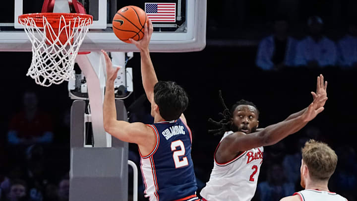Illinois Fighting Illini guard Andrej Stojakovic (2) shoots over Ohio State Buckeyes guard Bruce Thornton (2) during the first half of the NCAA men's basketball game in Columbus on Dec. 9, 2025. Ohio State lost 86-78. Illinois Fighting Illini guard Andrej Stojakovic (2) shoots over Ohio State Buckeyes guard Bruce Thornton (2) during the first half of the NCAA men's basketball game in Columbus on Dec. 9, 2025. Ohio State lost 86-78.