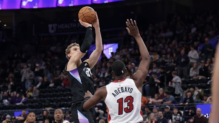 Jan 9, 2025; Salt Lake City, Utah, USA;  Utah Jazz forward Lauri Markkanen (23) shoots the ball past Miami Heat center Bam Adebayo (13) during the second half at Delta Center. Mandatory Credit: Chris Nicoll-Imagn Images