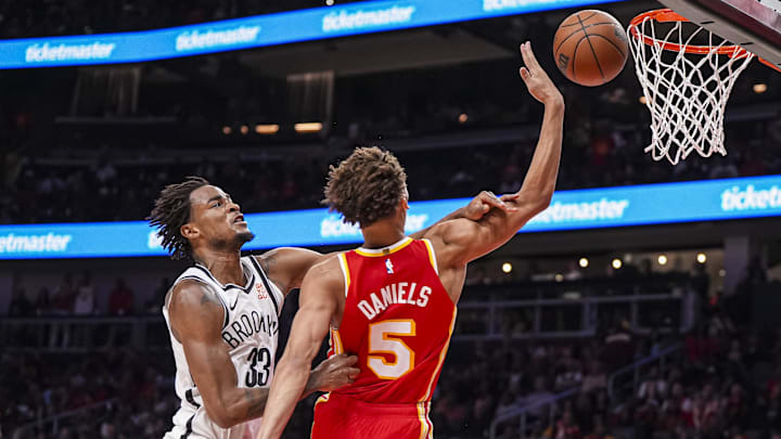 Oct 23, 2024; Atlanta, Georgia, USA; Brooklyn Nets center Nic Claxton (33) commits a flagrant two foul resulting in ejection on Atlanta Hawks guard Dyson Daniels (5) during the second half at State Farm Arena. Mandatory Credit: Dale Zanine-Imagn Images