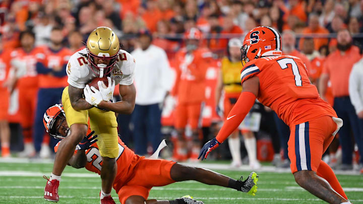 Nov 3, 2023; Syracuse, New York, USA; Boston College Eagles wide receiver Joseph Griffin Jr. (2) runs after a catch as Syracuse Orange defensive back Quan Peterson (22) and linebacker Stefon Thompson (7) defend during the first half at the JMA Wireless Dome. Mandatory Credit: Rich Barnes-Imagn Images