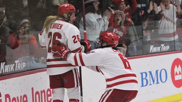 Wisconsin's Casey O'Brien (26) jumps for joy as Lacey Eden (6) closes in for a hug after O'Brien scored during the third period against Ohio State Saturday February 24, 2024 at La Bahn Arena in Madison, Wisconsin.