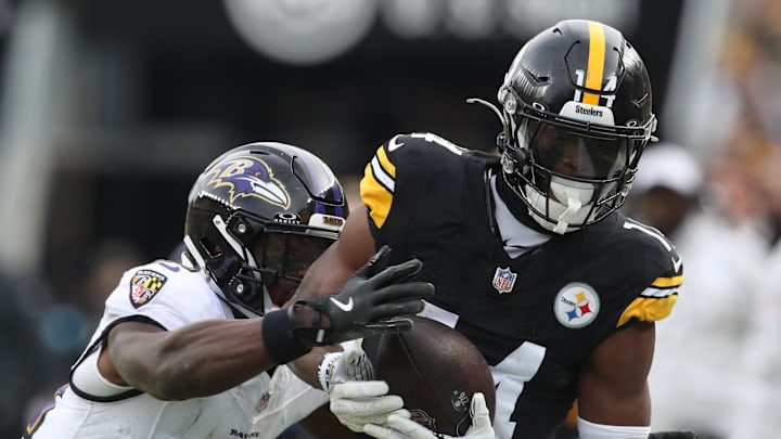 Nov 17, 2024; Pittsburgh, Pennsylvania, USA;  Pittsburgh Steelers wide receiver George Pickens (14) catches a pass against Baltimore Ravens cornerback Brandon Stephens (21) during the third quarter at Acrisure Stadium. Mandatory Credit: Charles LeClaire-Imagn Images