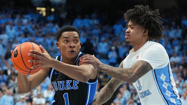 Duke guard Caleb Foster drives with the ball as North Carolina forward Jonathan Powell defends.