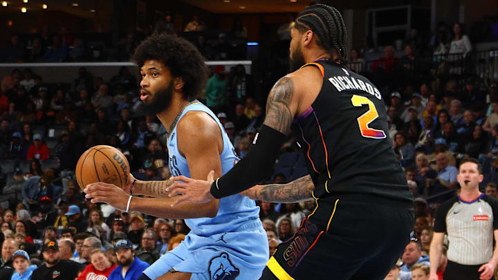 Mar 10, 2025; Memphis, Tennessee, USA; Memphis Grizzlies forward Marvin Bagley III (35) handles the ball as Phoenix Suns center Nick Richards (2) defends during the first quarter at FedExForum. Mandatory Credit: Petre Thomas-Imagn Images