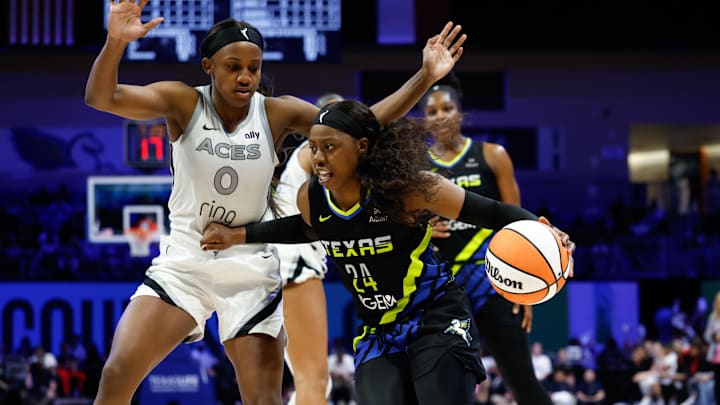 Dallas Wings guard Arike Ogunbowale drives to the basket against Las Vegas Aces guard Jackie Young.