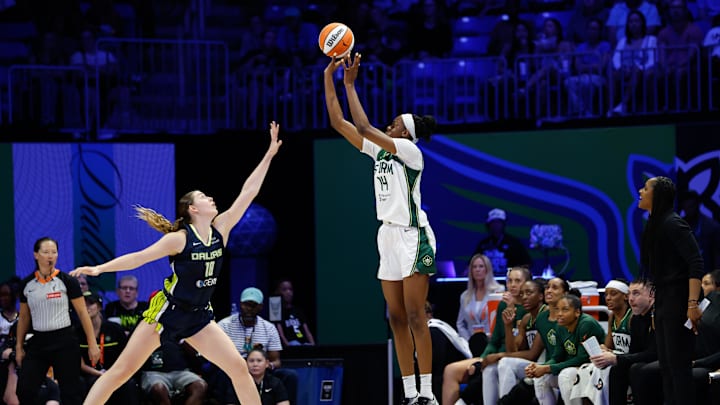 Seattle Storm center Dominique Malonga scores a three-point basket against Dallas Wings center Luisa Geiselsoder.