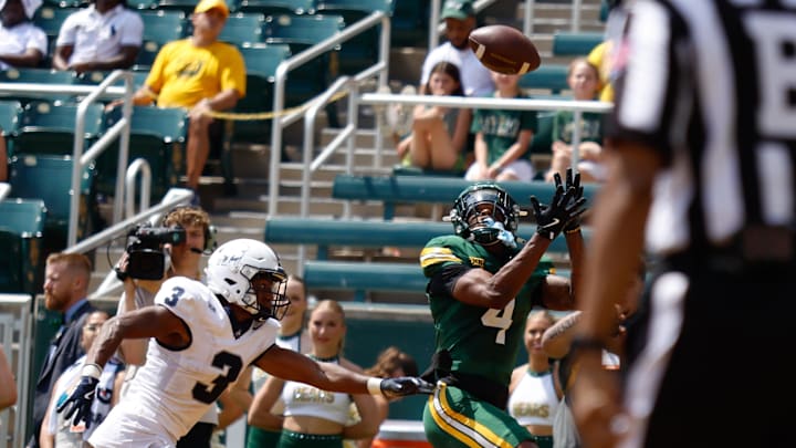 Sep 13, 2025; Waco, Texas, USA;  Baylor Bears wide receiver Louis Brown IV (4) catches a touchdown pass ahead of Samford Bulldogs cornerback Caidan Maddux (3) during the second half at McLane Stadium. Mandatory Credit: Chris Jones-Imagn Images