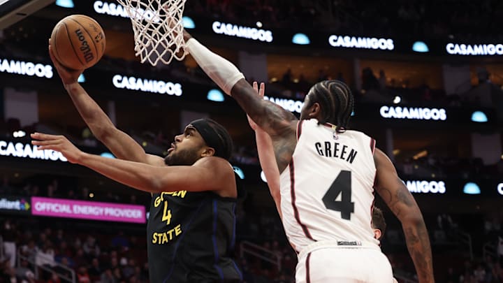 Feb 13, 2025; Houston, Texas, USA; Golden State Warriors guard Moses Moody (4) makes a basket against Houston Rockets guard Jalen Green (4) in the first half at Toyota Center. Mandatory Credit: Thomas Shea-Imagn Images