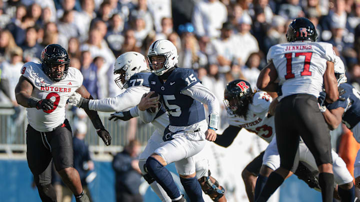 Nov 18, 2023; University Park, Pennsylvania, USA; Penn State Nittany Lions quarterback Drew Allar (15) carries the ball as Rutgers Scarlet Knights defensive lineman Isaiah Iton (9) pursues during the second half at Beaver Stadium. Mandatory Credit: Vincent Carchietta-Imagn Images