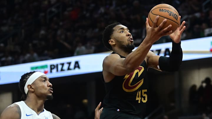 May 5, 2024; Cleveland, Ohio, USA; Cleveland Cavaliers guard Donovan Mitchell (45) drives to the basket against Orlando Magic center Wendell Carter Jr. (34) during the second half in game seven of the first round for the 2024 NBA playoffs at Rocket Mortgage FieldHouse. Mandatory Credit: Ken Blaze-USA TODAY Sports