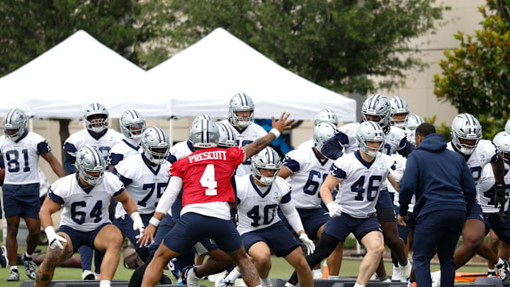 Jun 10, 2025; Arlington, TX, USA;  Dallas Cowboys quarterback Dak Prescott (4) leads teammates through a drill at the Ford Center at the Star Training Facility in Frisco, Texas. Mandatory Credit: Chris Jones-Imagn Images