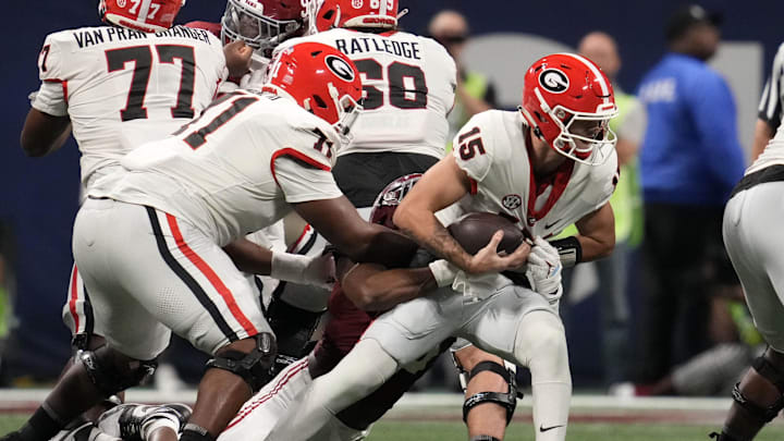 Dec 2, 2023; Atlanta, GA, USA; Alabama Crimson Tide linebacker Dallas Turner (15) sacks Georgia Bulldogs quarterback Carson Beck (15) during the first half in the SEC Championship game at Mercedes-Benz Stadium. Mandatory Credit: Dale Zanine-Imagn Images