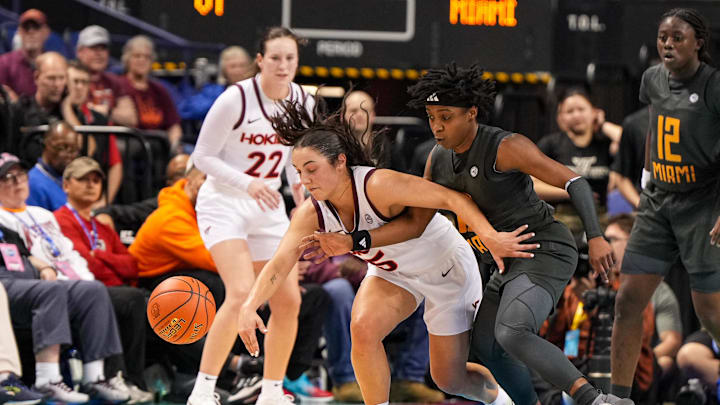 Mar 8, 2024; Greensboro, NC, USA; A Miami Hurricanes defender knocks the ball away from Virginia