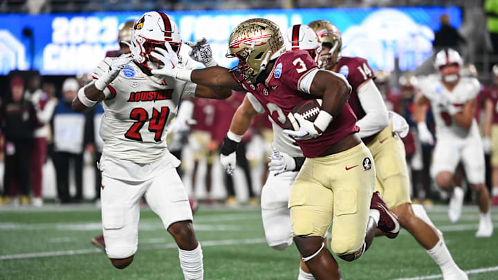 Dec 2, 2023; Charlotte, NC, USA; Florida State Seminoles running back Trey Benson (3) fends off