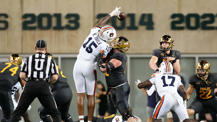 Aug 29, 2025; Waco, Texas, USA; Baylor Bears quarterback Sawyer Robertson (13) has his pass deflected by Auburn Tigers defensive end Keldric Faulk (15) during the second half at McLane Stadium. Mandatory Credit: Chris Jones-Imagn Images