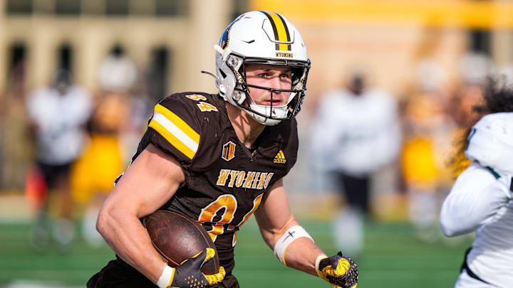 Nov 18, 2023; Laramie, Wyoming, USA; Wyoming Cowboys tight end John Michael Gyllenborg (84) scores a touchdown against the Hawaii Rainbow Warriors during the first quarter at Jonah Field at War Memorial Stadium. Mandatory Credit: Troy Babbitt-Imagn Images