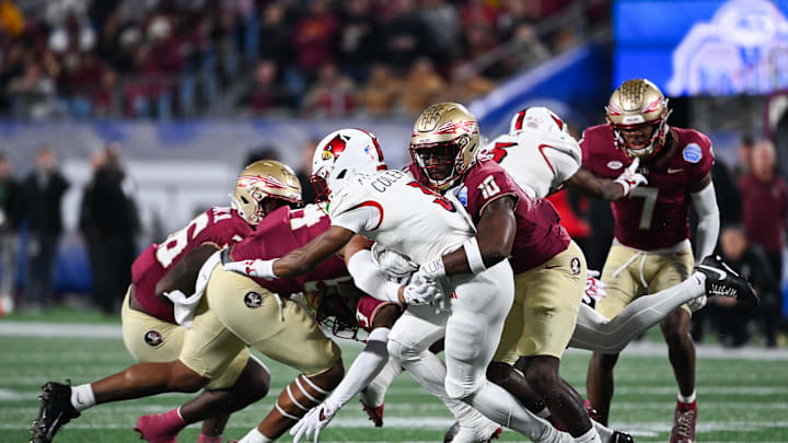 Dec 2, 2023; Charlotte, NC, USA; Louisville Cardinals wide receiver Kevin Coleman (3) is tackled by Florida State Seminoles linebacker DJ Lundy (10) in the first quarter at Bank of America Stadium. Mandatory Credit: Bob Donnan-USA TODAY Sports