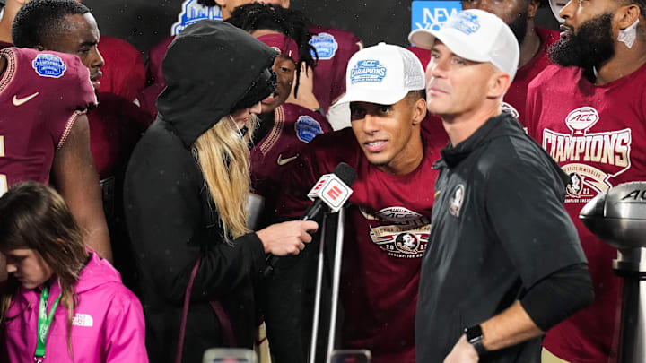 Dec 2, 2023; Charlotte, NC, USA; Florida State Seminoles quarterback Jordan Travis (13) does an interview after winning the ACC Championship game against the Louisville Cardinals at Bank of America Stadium. Mandatory Credit: Jim Dedmon-Imagn Images