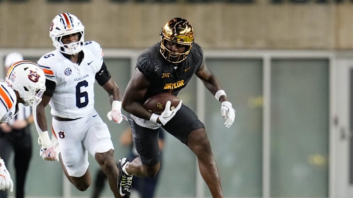 Aug 29, 2025; Waco, Texas, USA;  Baylor Bears tight end Michael Trigg (1) runs with the ball after the catch ahead of Auburn Tigers linebacker Demarcus Riddick (6) during the first half at McLane Stadium. Mandatory Credit: Chris Jones-Imagn Images