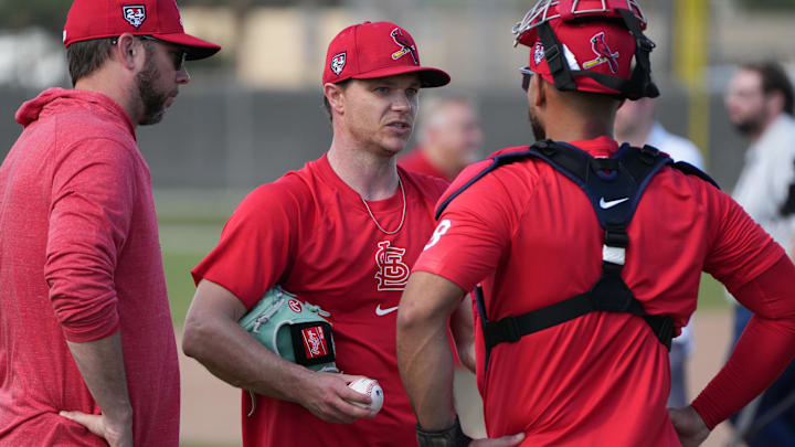 Feb 15, 2024; Jupiter, FL, USA;  St. Louis Cardinals starting pitcher Sonny Gray, center, talks with