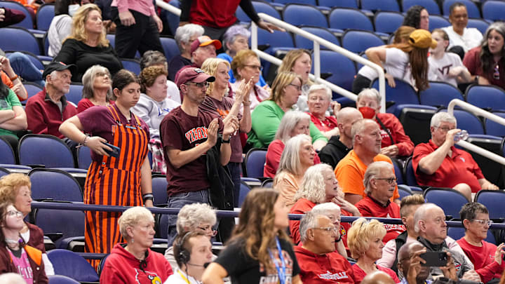 Mar 8, 2024; Greensboro, NC, USA; Virginia Tech Hokies fans applaud their team in the second half against the Miami Hurricanes at Greensboro Coliseum. Mandatory Credit: David Yeazell-Imagn Images