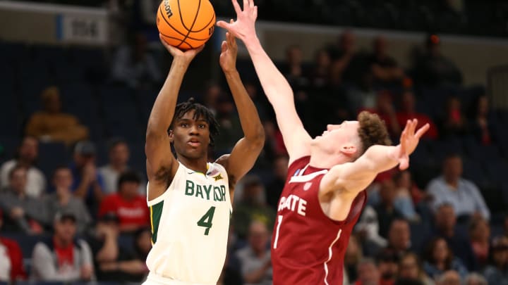 Mar 22, 2024; Memphis, TN, USA; Baylor Bears guard Ja'Kobe Walter (4) shoots over Colgate Raiders guard Brady Cummins (1) during the first half of the NCAA Tournament First Round at FedExForum. Mandatory Credit: Petre Thomas-USA TODAY Sports