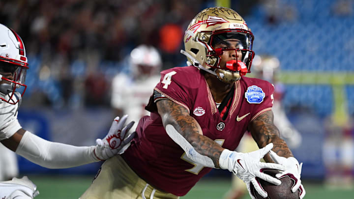 Dec 2, 2023; Charlotte, NC, USA; Florida State Seminoles wide receiver Keon Coleman (4) makes a catch against the Louisville Cardinals in the second quarter at Bank of America Stadium. Mandatory Credit: Bob Donnan-USA TODAY Sports