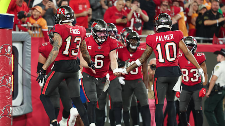 Jan 15, 2024; Tampa, Florida, USA;Tampa Bay Buccaneers quarterback Baker Mayfield (6) celebrates a touchdown with wide receivers Mike Evans (13) and Trey Palmer (10) against the Philadelphia Eagles during the first half of a 2024 NFC wild card game at Raymond James Stadium. Mandatory Credit: Kim Klement Neitzel-Imagn Images