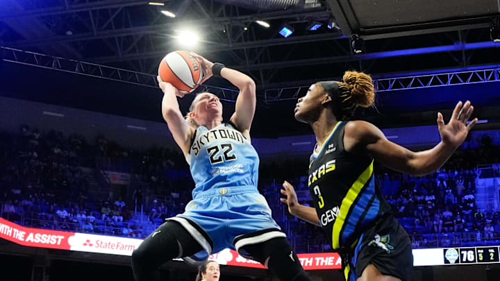 May 31, 2025; Arlington, Texas, USA;  Chicago Sky guard Courtney Vandersloot (22) scores a basket against Dallas Wings guard Kaila Charles (3) during the second half at College Park Center. Mandatory Credit: Chris Jones-Imagn Images