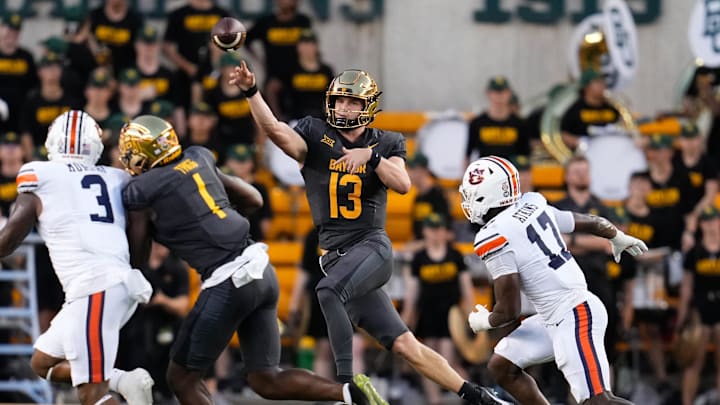 Aug 29, 2025; Waco, Texas, USA; Baylor Bears quarterback Sawyer Robertson (13) passes the ball as Auburn Tigers linebacker Xavier Atkins (17) gives chase during the first half at McLane Stadium. Mandatory Credit: Chris Jones-Imagn Images
