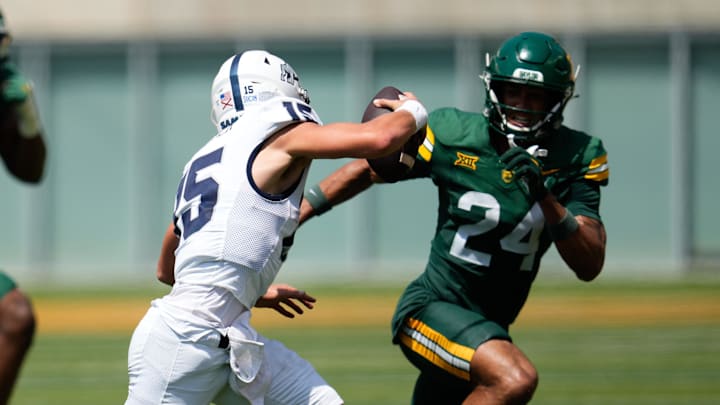 Sep 13, 2025; Waco, Texas, USA;  Samford Bulldogs quarterback Brady Stober (15) is pressured by Baylor Bears safety Micah Gifford (24) during the second half at McLane Stadium