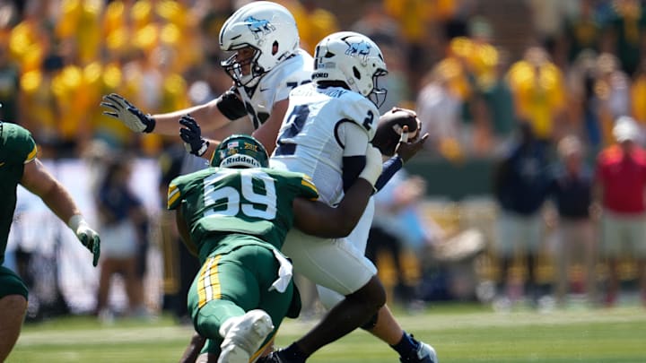 Sep 13, 2025; Waco, Texas, USA;  Samford Bulldogs quarterback Quincy Crittendon (2) is tackled by Baylor Bears defensive lineman Devonte Tezino (59) for a short gain during the first half at McLane Stadium. Mandatory Credit: Chris Jones-Imagn Images