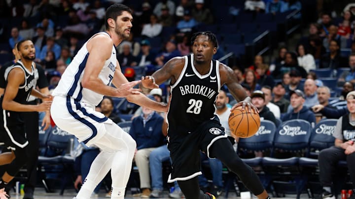 Feb 26, 2024; Memphis, Tennessee, USA; Brooklyn Nets forward Dorian Finney-Smith (28) drives to the basket as Memphis Grizzlies forward-center Santi Aldama (7) defends during the second half at FedExForum. Mandatory Credit: Petre Thomas-Imagn Images
