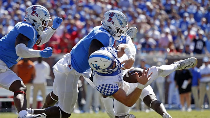 Oct 1, 2022; Oxford, Mississippi, USA; Mississippi Rebels linebacker Troy Brown (8), linebacker Austin Keys (11) and defensive back AJ Finley (21) force the fumble by Kentucky Wildcats quarterback Will Levis (7) during the fourth quarter at Vaught-Hemingway Stadium. Mandatory Credit: Petre Thomas-Imagn Images