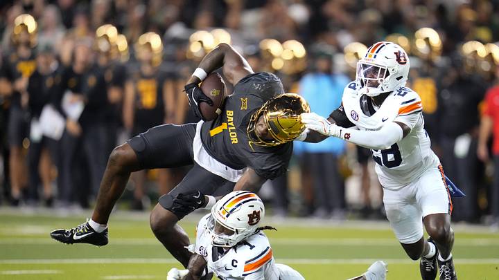 Aug 29, 2025; Waco, Texas, USA;  Baylor Bears tight end Michael Trigg (1) makes a catch as Auburn Tigers safety Champ Anthony
