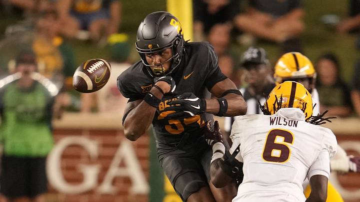 Sep 20, 2025; Waco, Texas, USA; Baylor Bears wide receiver Josh Cameron (34) fumbles the ball as he is hit by Arizona State Sun Devils safety Adrian Wilson