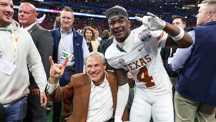 Jan 1, 2025; Atlanta, GA, USA; Texas governor Greg Abbott poses with Texas Longhorns defensive back Andrew Mukuba (4) after a victory over the Arizona State Sun Devils in the Peach Bowl at Mercedes-Benz Stadium. Mandatory Credit: Brett Davis-Imagn Images Jan 1, 2025; Atlanta, GA, USA; Texas governor Greg Abbott poses with Texas Longhorns defensive back Andrew Mukuba (4) after a victory over the Arizona State Sun Devils in the Peach Bowl at Mercedes-Benz Stadium. Mandatory Credit: Brett Davis-Imagn Images