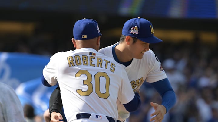Mar 27, 2025; Los Angeles, California, USA; Los Angeles Dodgers two-way player Shohei Ohtani (17) reacts with manager Dave Roberts (30) before the game against the Detroit Tigers at Dodger Stadium. Mandatory Credit: Jayne Kamin-Oncea-Imagn Images
