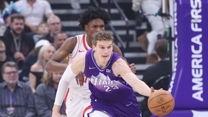 Feb 22, 2025; Salt Lake City, Utah, USA; Utah Jazz forward Lauri Markkanen (23) brings the ball up the court against Houston Rockets forward Amen Thompson (back) during the first half at Delta Center. Mandatory Credit: Rob Gray-Imagn Images