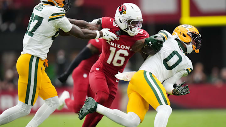 Arizona Cardinals cornerback Max Melton (16) breaks away from a block by Green Bay Packers receiver Romeo Doubs (87) to tackle Matthew Golden (0) at State Farm Stadium in Glendale on Oct. 19, 2025.