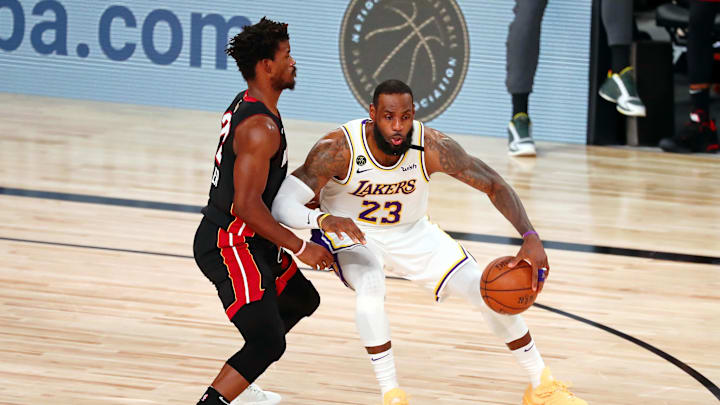 Oct 11, 2020; Lake Buena Vista, Florida, USA; Los Angeles Lakers forward LeBron James (23) dribbles while defended by Miami Heat forward Jimmy Butler (22) during the third quarter in game six of the 2020 NBA Finals at AdventHealth Arena. Mandatory Credit: Kim Klement-Imagn Images