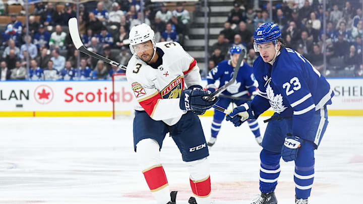 Mar 13, 2025; Toronto, Ontario, CAN; Toronto Maple Leafs left wing Matthew Knies (23) battles with Florida Panthers defenseman Seth Jones (3) during the first period at Scotiabank Arena. Mandatory Credit: Nick Turchiaro-Imagn Images
