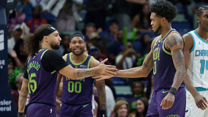 New Orleans Pelicans guard Jose Alvarado (15) shakes hands with ex-Husky forward Keion Brooks Jr., who had a big night. 